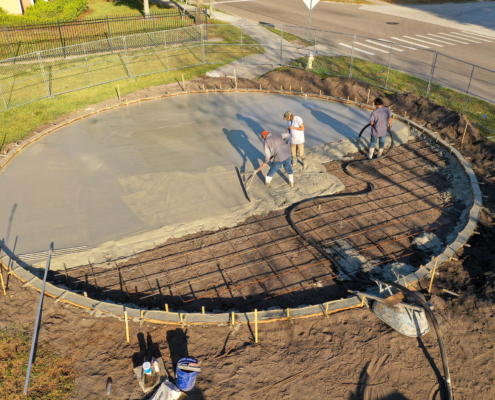Crew pours the concrete base of a FitLot Outdoor Fitness Park